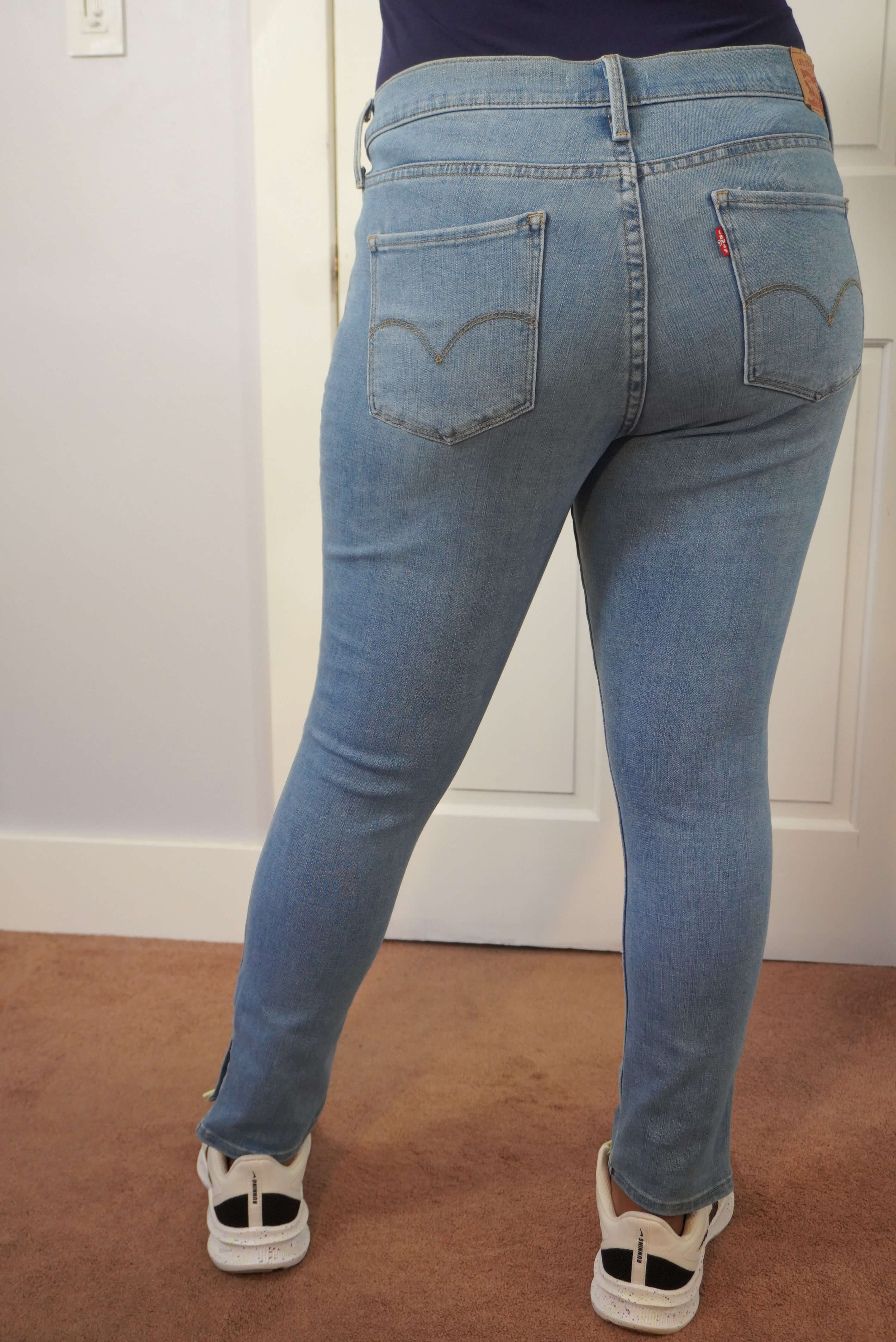 This image shows the back view of a pair of Levi's 311 skinny shaping on the author. The back pockets and tight fit of the jeans are displayed.
