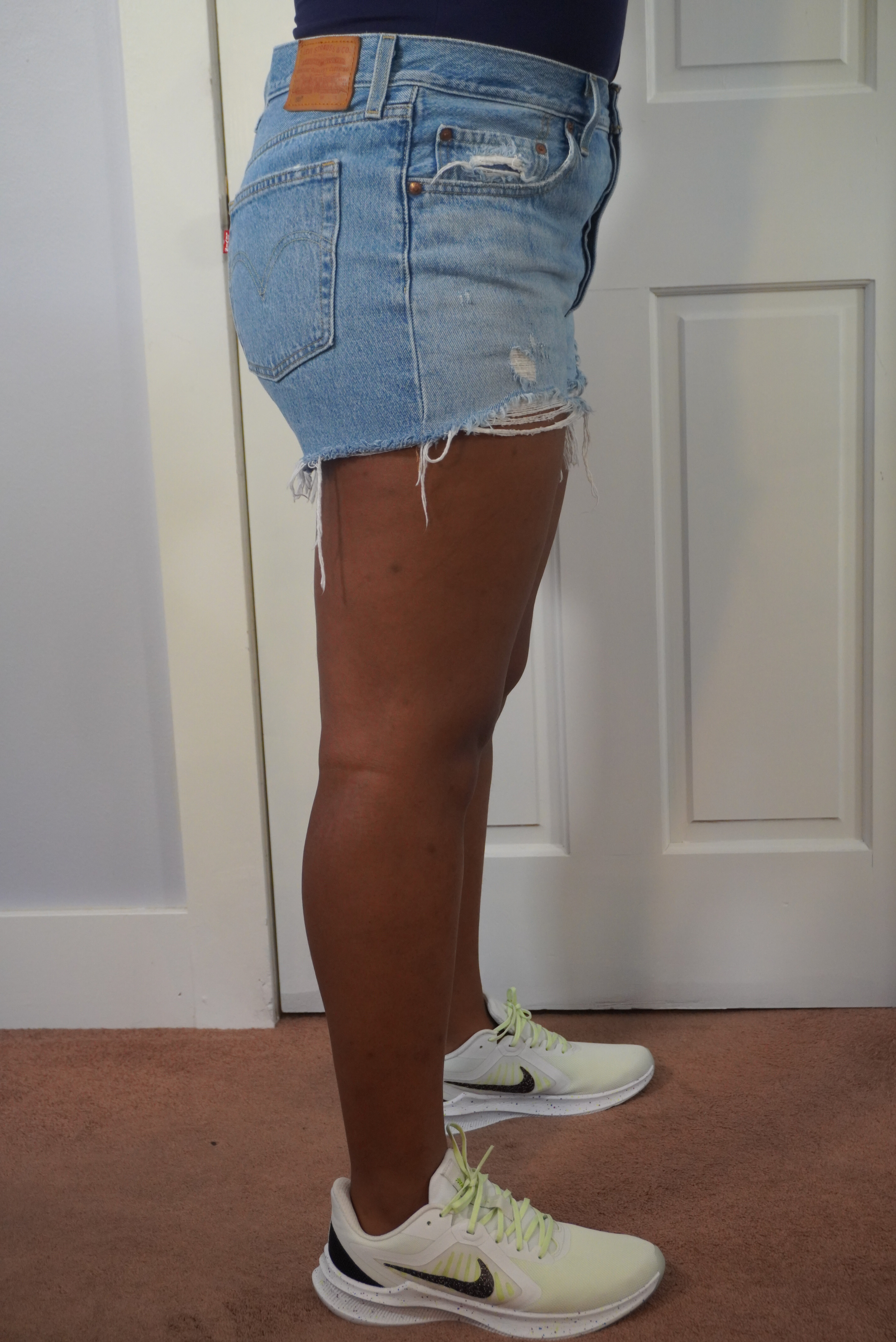 This image shows a side view of a pair of 501 Levi's shorts on the author. The side view shows the brown Levi's patch and the pockets with rivets.