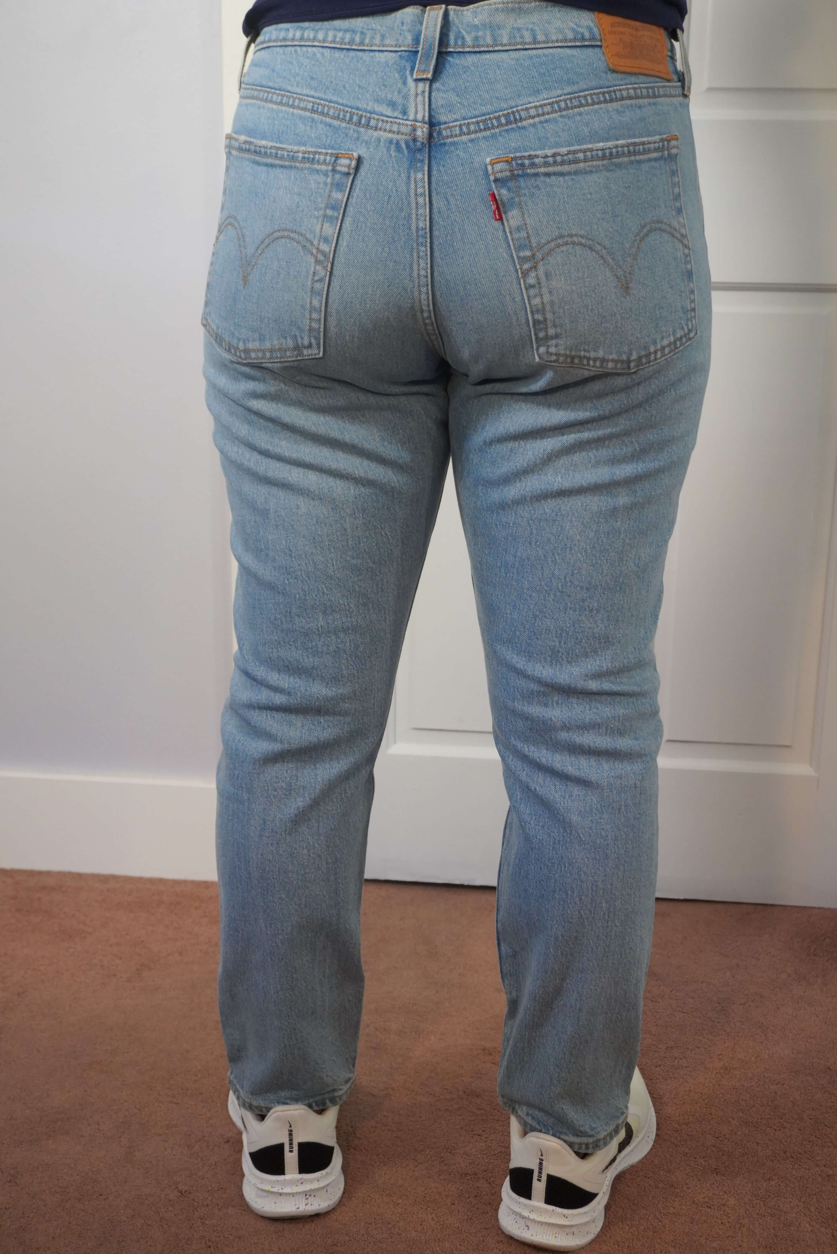 This image shows a back view of the author wearing a pair of Levi's Wedgie jeans in a light blue wash. This shows a tighter fit in the buttocks area.