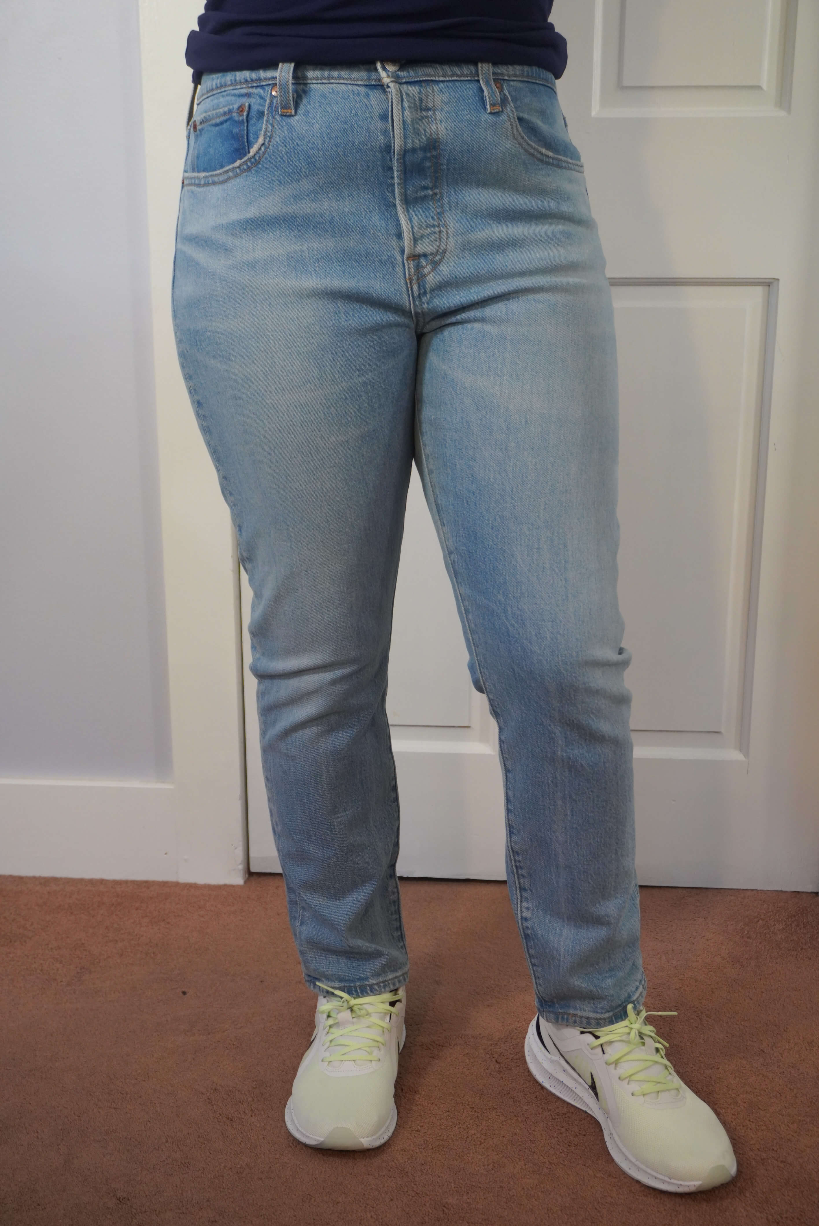 This image shows a front view of the author wearing a pair of plain Levi's Wedgie jeans in a light blue wash. This shows the relaxed fit in the front.