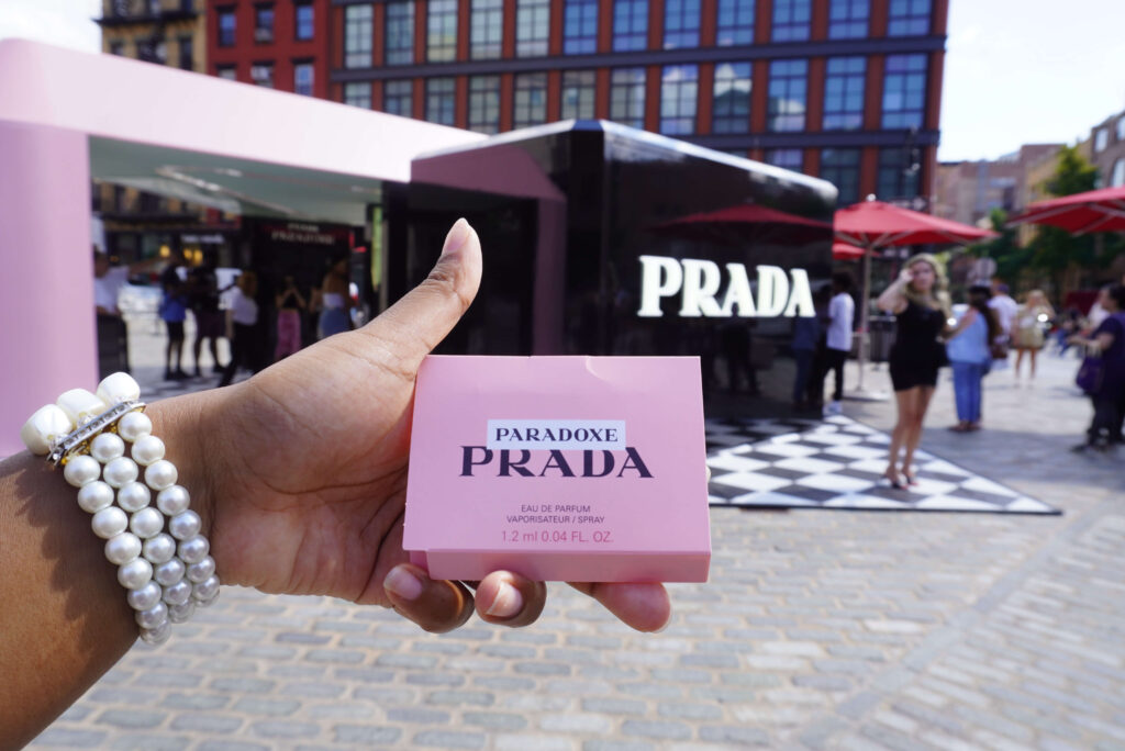 Image of me holding Prada Paradoxe sample in my hand at the Prada pop-up event.