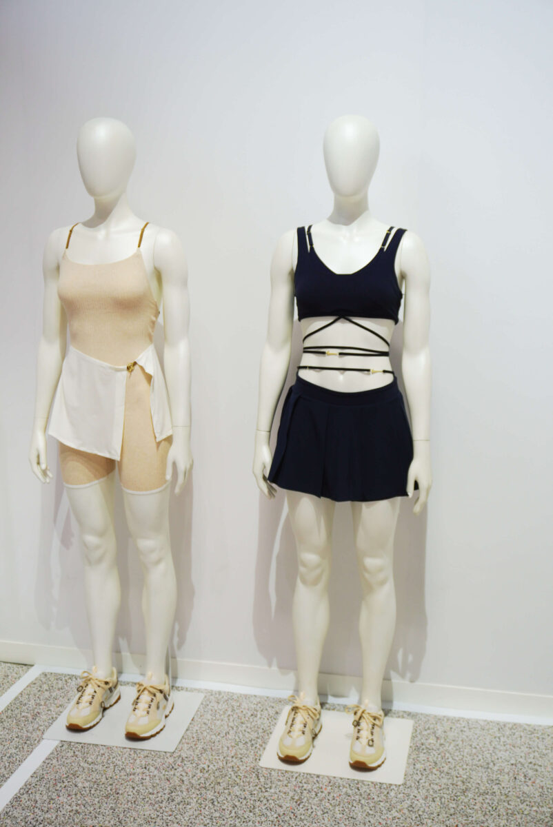 Images of two mannequins dressed in blue and beige activewear from the Nike x Jacquemus collaboration