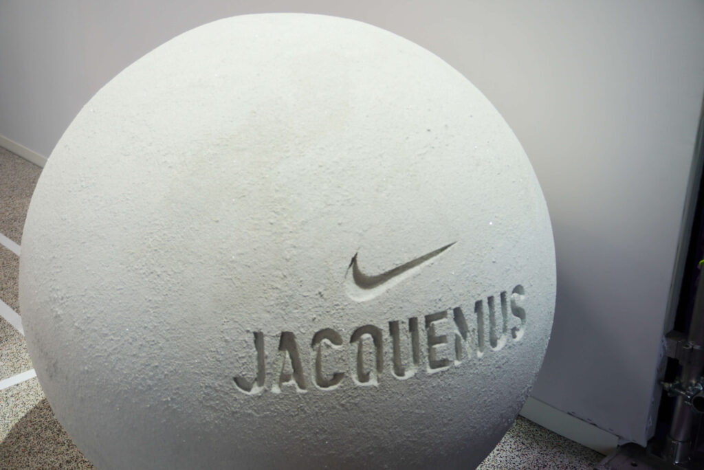 Image of a round ball prop with the Nike logo and the name Jacquemus etched on it