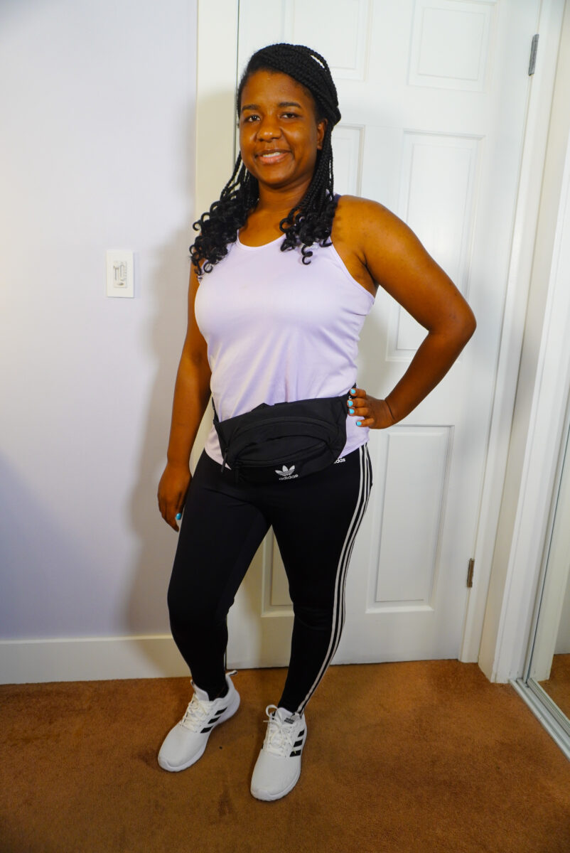Image of me wearing white Adidas shoes with full length leggings and a purple tank top.