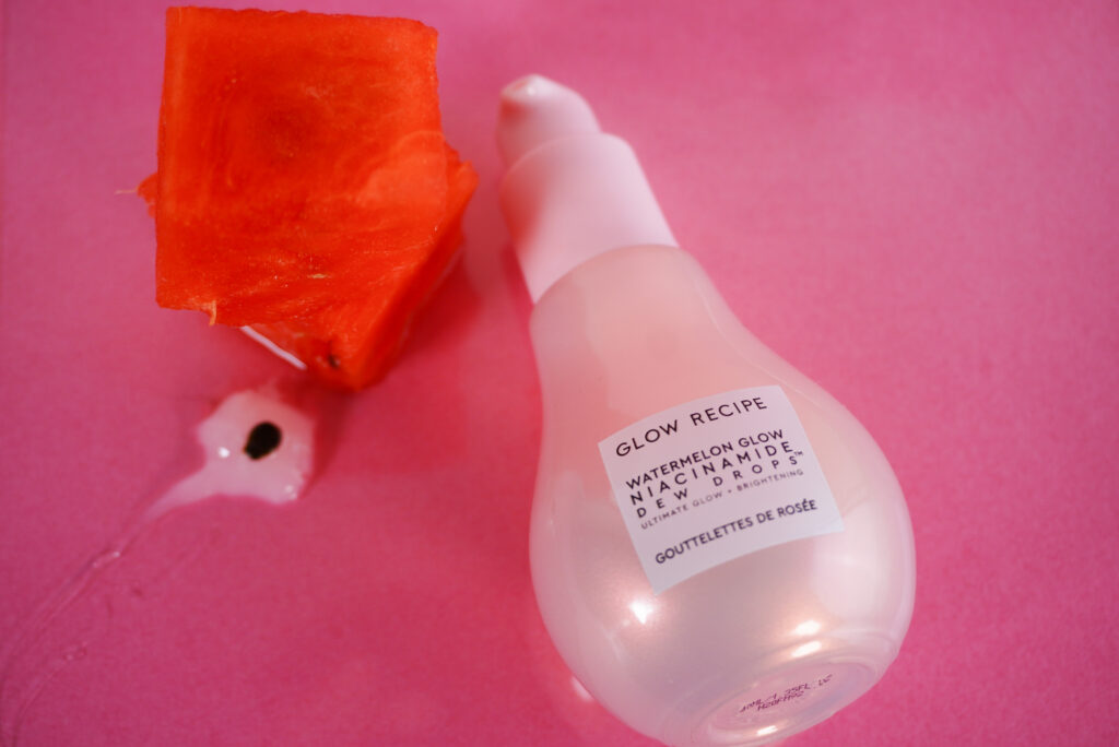 Image of Glow Recipe bottle face up with watermelon next to it.