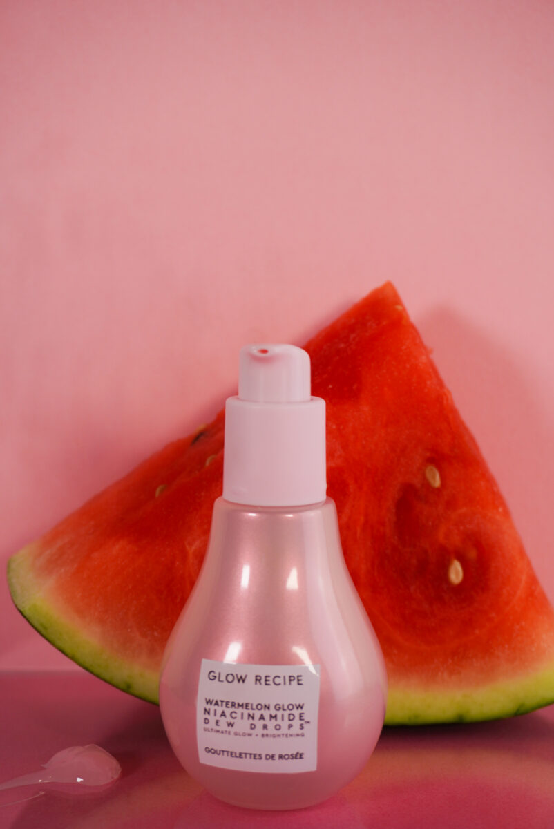 Image of the bottle in front of a watermelon