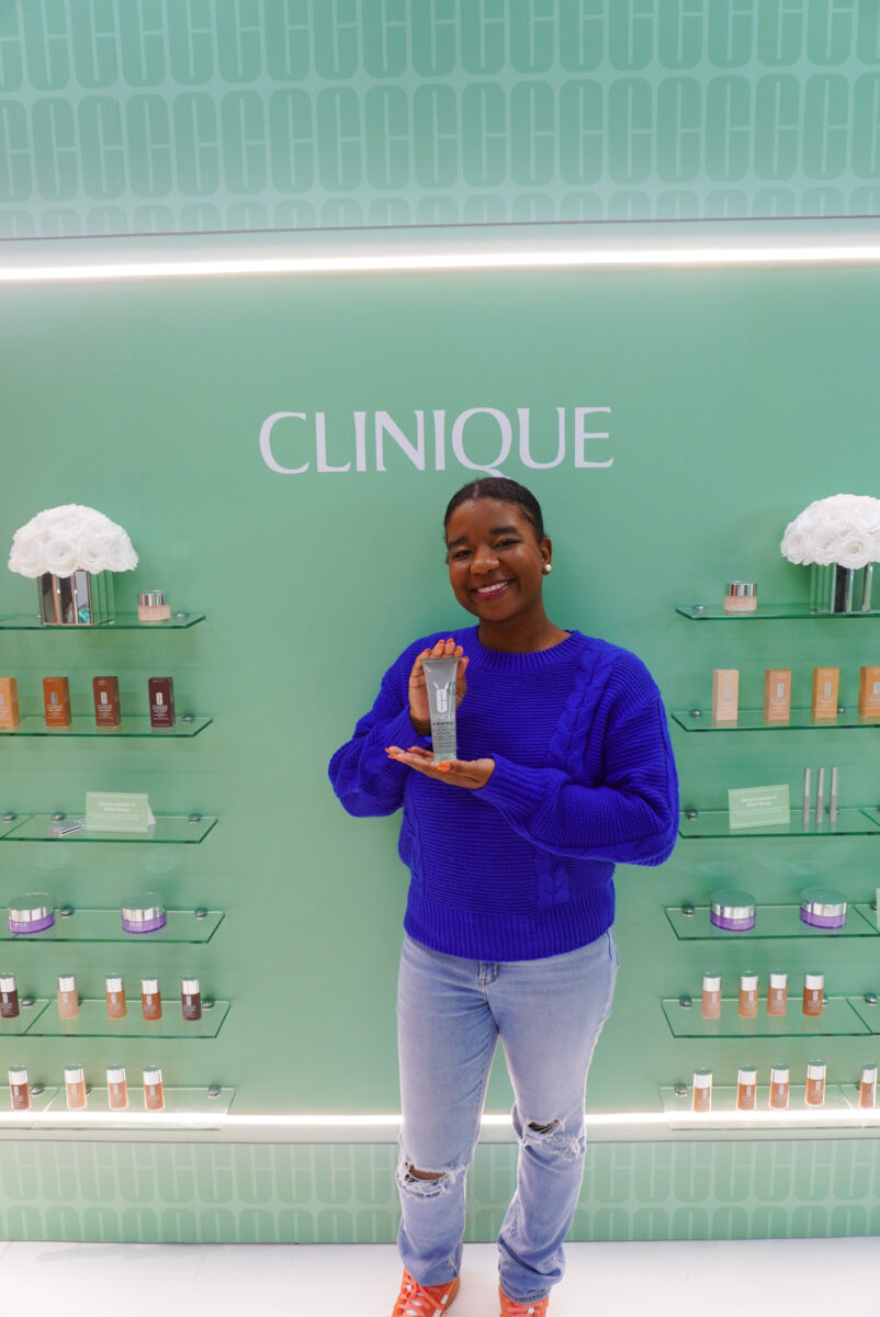 Image of me smiling holding a Clinique product.