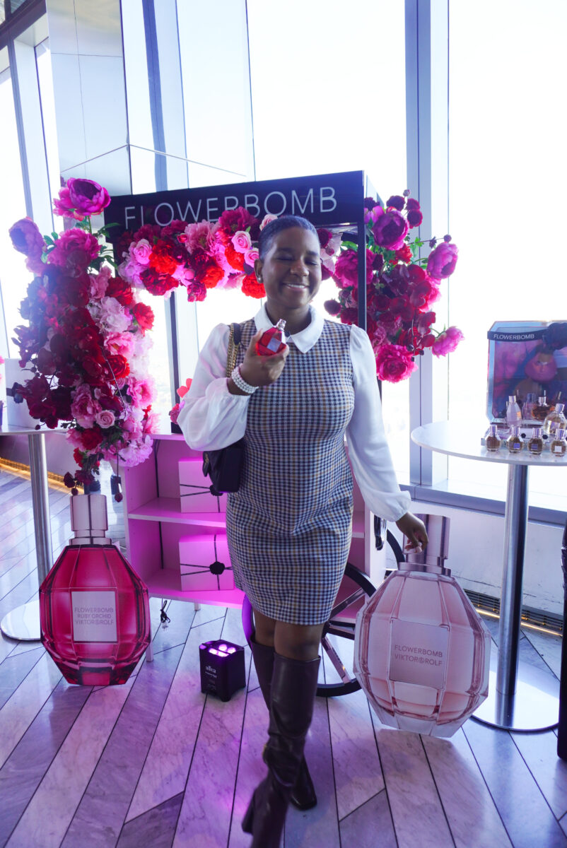 Image of me posing in front of the Viktor & Rolf Flowerbomb perfume cart.