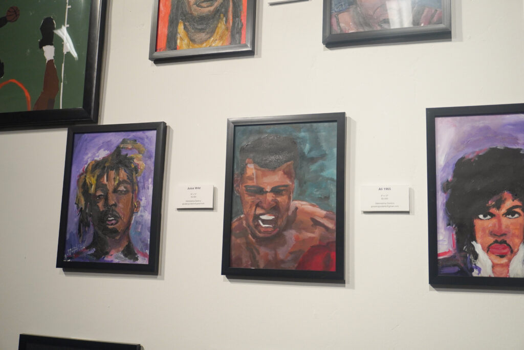 Image of Glenneisha Darkins, oil paintings of Prince, Juice Wrld, and Muhammad Ali.