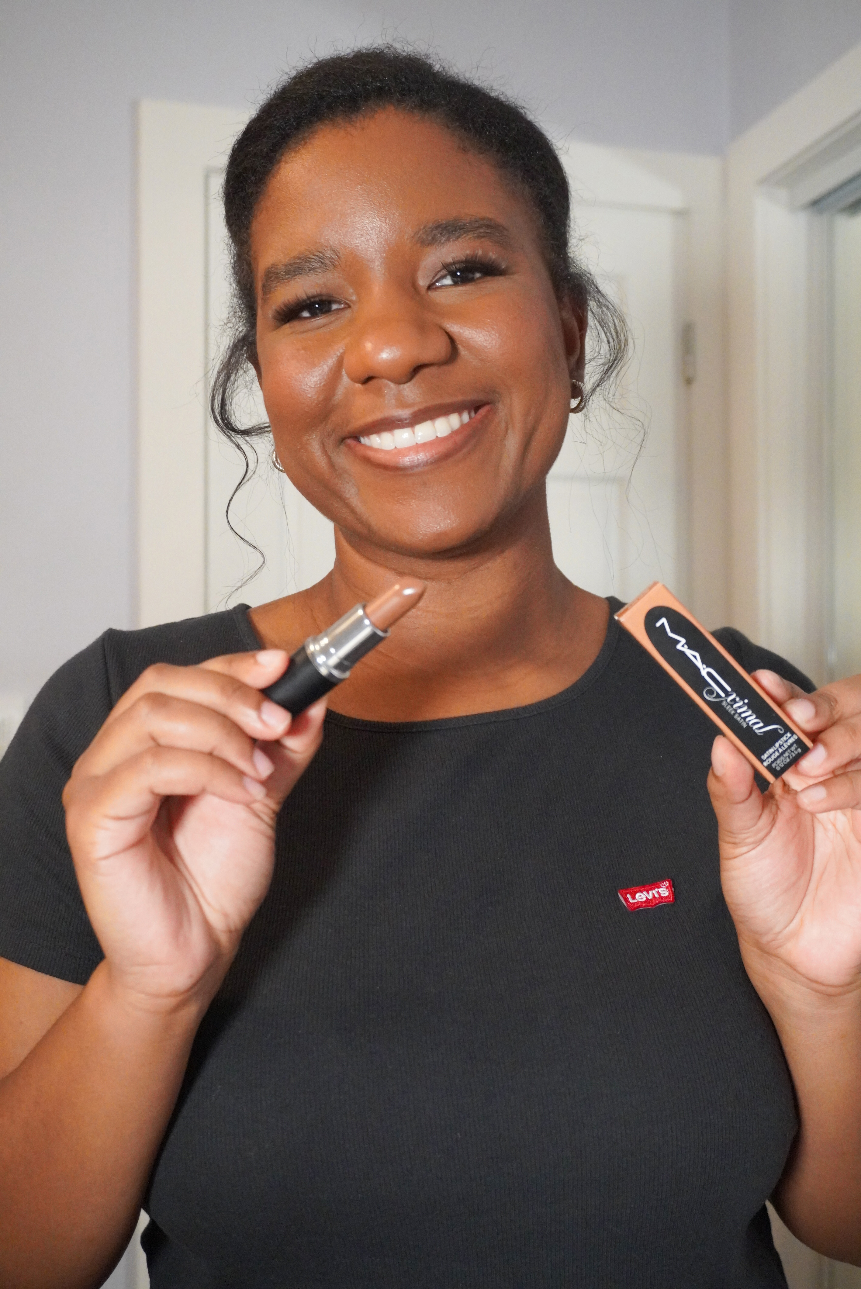 Image of me holding MAC lipstick in shade hodge