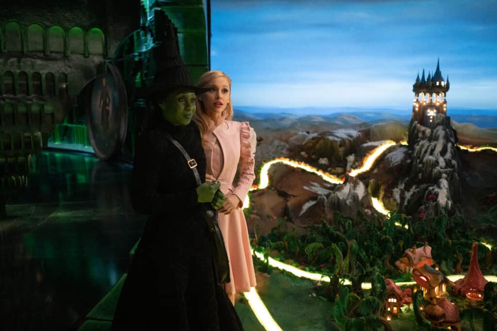Image of Elphaba and Glinda at the Wizards castle with a model size replica of Fiyero's castle, Kiamo Ko in the background.