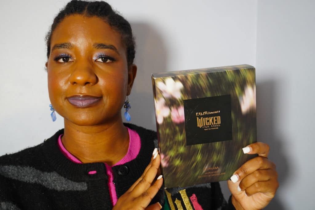 Image of me holding the Elphaba set from the Wicked x R.E.M. Beauty collection.